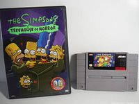 DVD case featuring The Simpsons Treehouse of Horror cover art and SNES game cartridge with matching labels.