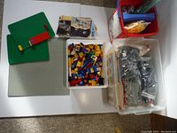 Overview of bins and baseplates on table surface showing instruction sheets