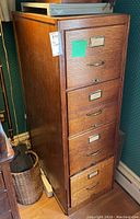 Angled side-front view of cabinet showing all four drawers and overall condition