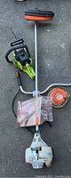 Poulan 2150 electric chainsaw, no chain attached, shown with Stihl FS90 weed whacker.