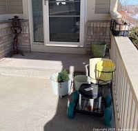 Photo showing all items on porch including garden pots, metal pot holders, rolling garden seat, and Asian style light.