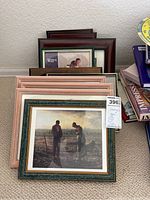 Stack of 11 small picture frames with some stacked haphazardly, visible one with an outdoor scene image featuring two people and child, other frames showing wood and pink colors.