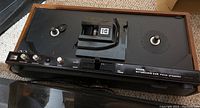 Top view of Kodak Ektasound 245 movie projector showing dual reel spindles, control knobs, and Kodak branding on front panel.