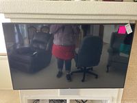 Front view of the 60-inch LG TV mounted on wall