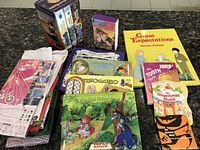 Overview of the books and headgear on countertop showing lot contents including box set, pop-up books, and headgear in packaging.