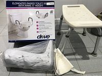 Photo showing the raised toilet seat, padded armrests, and packaging box.