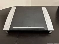 Fellowes laptop riser top surface and side supports on table.
