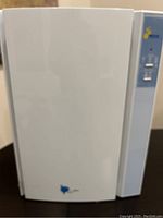 Front view of the white Nanoxi air purifier unit showing clean design and logo.