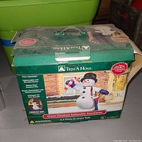 Photo of the closed retail box showing brand Trim A Home and details about the inflatable snowman.