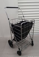 Side angle showing metal frame, fabric bag, and wheels.