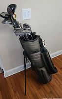 Golf bag standing upright showing clubs inside with different heads visible