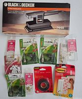 Boxed Black & Decker 1/3 sheet finishing sander along with various picture hanger packages and one pack of 3M Scotch electrical tape