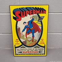 Front of the wooden art with vintage Superman comic cover design featuring Superman flying and bright yellow background.