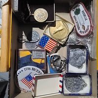 Drawer with bicentennial jewelry, pins, patches, and assorted medals