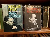 Photo showing covers of two featured books, Sinclair Lewis biography by Mark Schorer and Letters of Marshall McLuhan with visible vintage wear