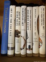 Spine view of all 7 hardcover art history books with visible titles and authors.