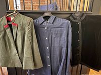 Three clothing items on hangers: khaki Austrian Elegance wool jacket with red piping, navy Ralph Lauren linen shirt, black velvet Yves Saint Laurent jacket