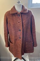 Full front view of vintage women's wool coat, showing button front, two large front pockets, and wide collar.