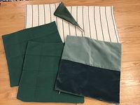Overview of five velvet throw pillow covers in shades of green, showing front and back sides and brass zippers