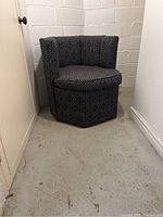 Front view of hexagon accent chair against concrete block wall
