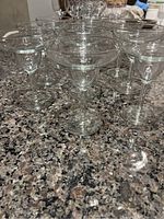 Front view showing the full set of ten clear margarita glasses arranged on a countertop.