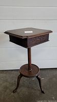 Full view of antique wooden cigar stand closed.