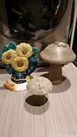 Cast iron sunflower and two stone toadstools on floor, showing overall lot contents