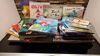 Photo of assorted children's picture books piled together including Olivia, Town Is by the Sea, I Knew You Could!, The Little Mermaid, Ducks on the Muck among others.