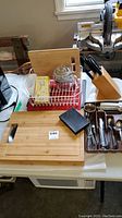 Full lot overview with percolator, cutting boards, knife block, utensils and dish rack