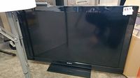 Front view of Sony Bravia LCD TV turned off, showing screen and stand.