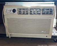 Front view of the beige Whirlpool window air conditioner unit with three air vents and control panel visible.