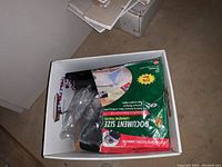 Box showing laminating pouch packaging and partial view of laminator