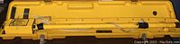 Locator and telescoping rod inside open yellow carrying case