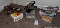 Three pairs of women's shoes photographed on carpet with two pairs on Selby boxes and one pair on Magdesians box.
