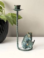 Full view of the brass candlestick holder with mouse figure against a plain background, showing the height and general condition.