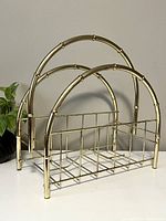 Front angled view showing the bamboo-style arches and metal grid base of the rack with visible wear to coloring.