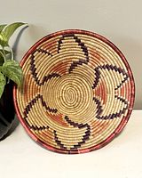 Top-down view showing circular geometric pattern in natural, burgundy, and reddish colors.