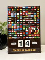 Front view of calendar showing colorful world flags and date set to Tuesday, February 14.