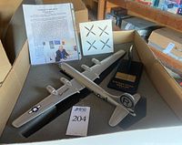 All components in foam-lined box with model, stand, propellers, and certificate.