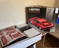 Opened box showing kit components and outer box with Ferrari Testarossa branding