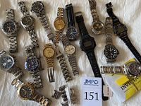 All fifteen watches laid out on white cloth showing assortment
