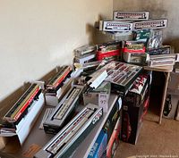 Overall lot of boxed HO scale train cars and accessories on tables