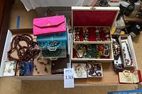 Overview of assorted jewelry, pouches and boxes on tabletop