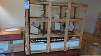 Warship model inside wooden shipping crate with styrofoam base and strapped bands
