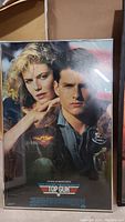 Framed Top Gun 1986 movie poster showing the main characters Tom Cruise and Kelly McGillis, close up of the front artwork.