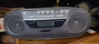 Front view of Sony CD player, radio tuner, and cassette player with control buttons and mesh speakers on both sides.