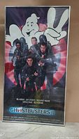 Front view of the framed Ghostbusters II movie poster showing main characters and logo.