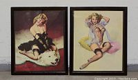 Both prints in dark wood frames displayed side by side against a wall.