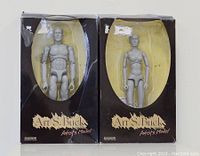 Original packaged male and female Art S Buck artist figures showing boxes' wear and intact inside figures.