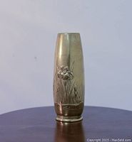 Front view of the brass vase showing floral motifs